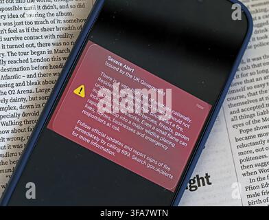 Smartphone showing the 14 August 2026 UK Government wildfire alert, warning the public to avoid barbecues, firepits, fireworks and open flames Stock Photo