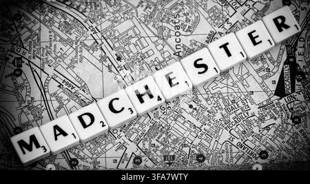 Madchester letter tiles across a Manchester A-Z map, evoking Factory Records, The Haçienda, famous bands and the city's music personalities Stock Photo