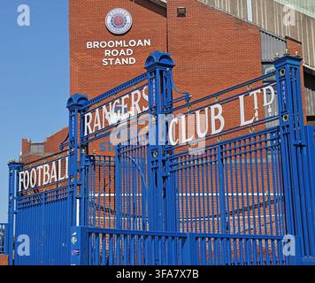 Ornate blue Glasgow Rangers FC iron gates and Broomloan Road Stand at historic Ibrox Stadium, home of Rangers in Glasgow, Scotland. Stock Photo