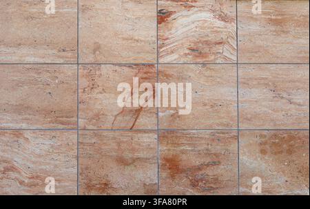 Reddish pink  travertine square tiles for floor or wall coating. Full frame, background and texture. Stock Photo