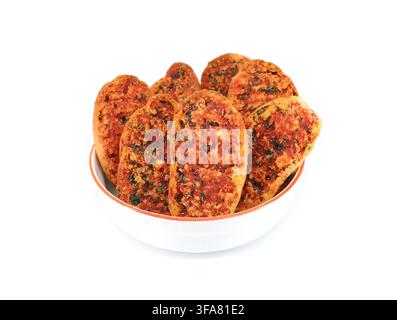 Crispbreads with tomato and oregano in a bowl on white background. Stock Photo