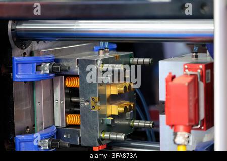 Metal mold closeup in plastic injection moulding machine. Selective focus. Stock Photo