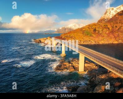 Aerial view of bridge, sea with waves and mountains at sunset Stock Photo