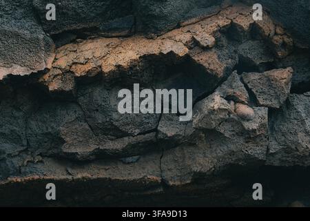 Cracked and porous solidified lava forming a rugged volcanic texture. Stock Photo
