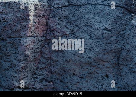 Porous volcanic rock surface with natural cracks and cavities in Lanzarote. Stock Photo