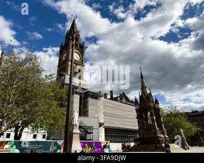 Manchester, UK - May 10, 2026: Victorian clock tower and ornate Gothic memorial in Manchester city square under dramatic cloudy sky. Stock Photo