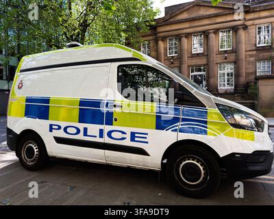 Manchester, UK - May 10, 2026: Police van with blue and yellow markings parked on a Manchester UK street outside a historic meeting house. Stock Photo
