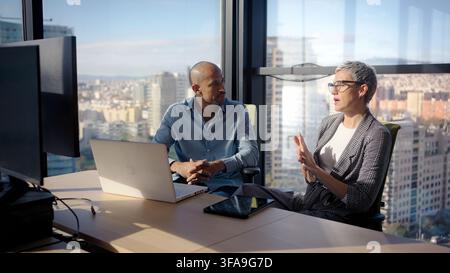 Business colleagues discussing strategy in modern office Stock Photo