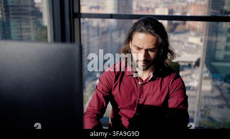 Focused man working on laptop in office Stock Photo