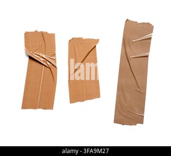 Brown adhesive tape pieces, sticky texture and ripped edges, packaging and repair concept isolated on white background Stock Photo