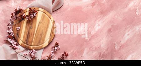 Empty wooden round tray with pink flowers on pink textured background Stock Photo