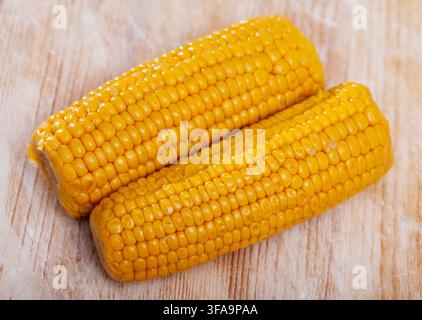 Boiled sweet corn on wooden table Stock Photo