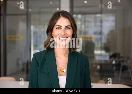 Head shot of young Mexican businesswoman smiling, looking at camera Stock Photo