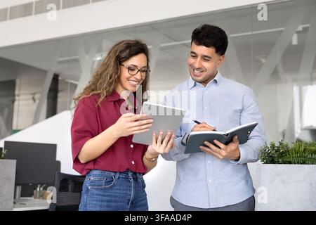 Colleagues discussing project updates, working on ideas or corporate tasks Stock Photo
