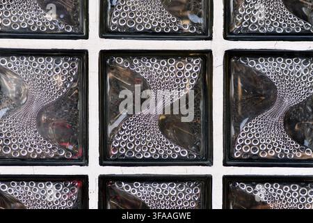 Textured translucent glass block wall with curved circular pattern Stock Photo