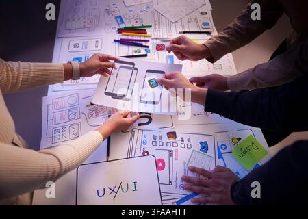 UX UI design team planning mobile application interface wireframes overhead view Stock Photo