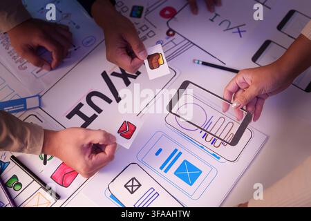 UX UI designer team collaborating on mobile app interface wireframe layout prototype Stock Photo