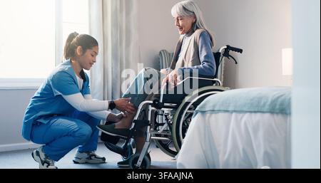 Senior, woman and nurse helping patient in wheelchair for assisted living, recovery or medical aid. Caregiver, elderly care or female person with a Stock Photo