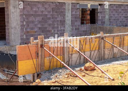Wooden formwork and steel reinforcement bars are prepared for pouring concrete on a building construction site Stock Photo