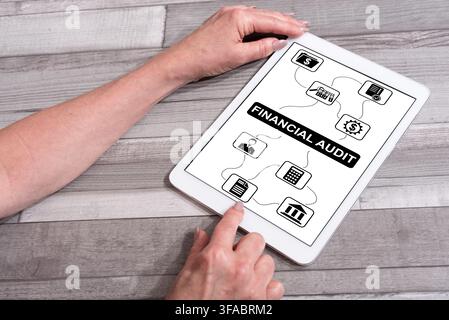 Financial audit concept shown on a tablet used by a woman Stock Photo