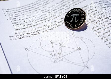 Pi emblem coin rests on an open math book showing a precise geometric construction with intersecting circles and lines in sunlight conveying study foc Stock Photo