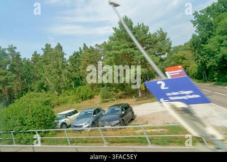 Soft tourism and recreational mobility along rural roads in Brandenburg during August, captured from a moving vehicle with visible motion blur emphasi Stock Photo