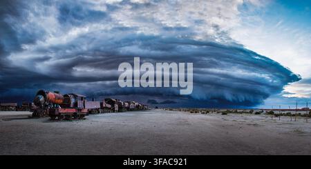 "Massive shelf cloud storm formation looming over the historic Train Cemetery in Uyuni, Potosi, Bolivia." Stock Photo