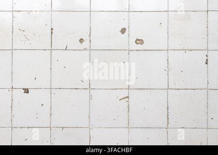 weathered grunge white ceramic tile wall abstract background texture Stock Photo