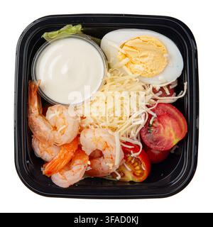 Caesar salad with shrimp and sauce box isolated Stock Photo