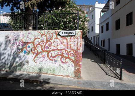 Colourful handprint tree mural outside the Asociación de Mujeres La Otra Mirada women's association in Órgiva, Las Alpujarras, Granada province, Andal Stock Photo
