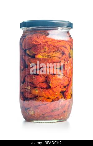 Close-up of a glass jar filled with sun-dried tomatoes preserved in oil, highlighting rich red color, wrinkled texture and homemade, artisanal appeal Stock Photo