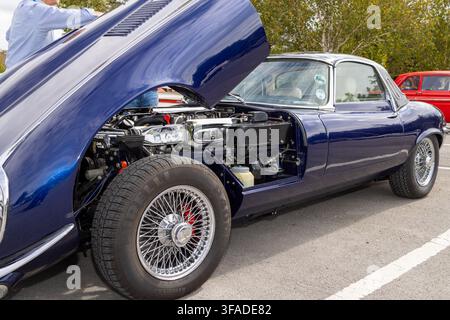 Harrogate, Yorkshire UK 17th August 2026: Classic Jaguar E-Type coupe in dark blue with bonnet raised revealing the engine bay and mechanical componen Stock Photo