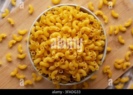 Dry Organic Elbow Macaroni Pasta in a Bowl, top view. Stock Photo