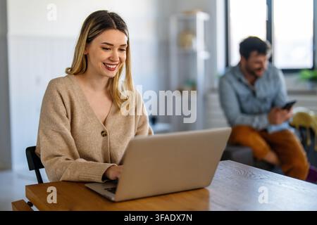 Young female designer, freelancer working in the office. Female using laptop to searching info. Stock Photo