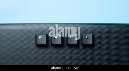 Minimal fail word made from keyboard keys on a dark surface, suitable for failure, mistake, risk, work pressure, crisis, and negative result concepts. Stock Photo