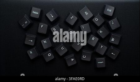 Scattered Computer Keyboard Keys On Dark Background ideal for technology, computer hardware, digital chaos, data disorder, coding Stock Photo