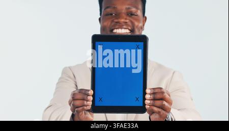 Portrait, businessman and tablet in studio with green screen, digital marketing and presentation. Happy, black person and tech for online advertising Stock Photo