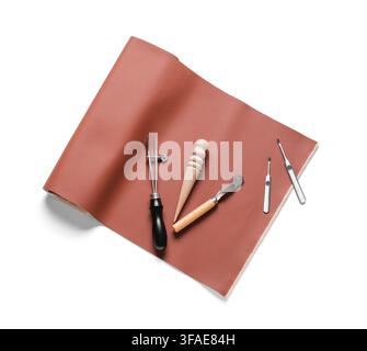 Leather crafting and handmade goods concept, tools for working with leather on a brown material background Stock Photo