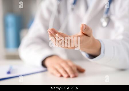 Healthcare support and medical assistance, doctors open hand offering help or receiving payment in a clinic setting Stock Photo