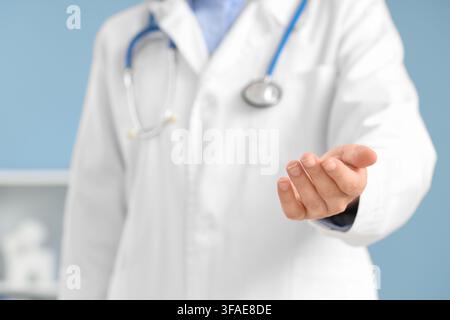 Medical care and healthcare services, doctor offering helping hand, professional support and assistance in clinic Stock Photo