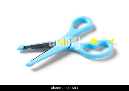 Childrens safety scissors for school and craft projects, blue plastic with yellow accents, isolated on white background Stock Photo