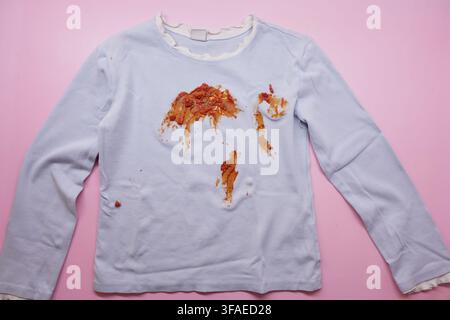 Shirt with stains on light pink background Stock Photo