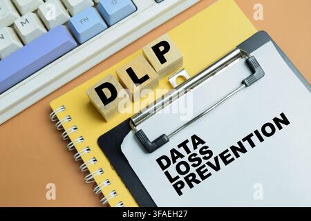 Concept of DLP - Data Loss Prevention write on clipboard isolated on table. Stock Photo