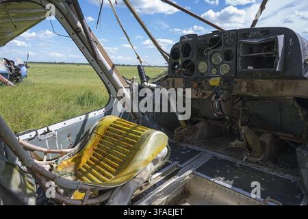 A dilapidated cockpit of an aircraft with a rusty seat and old flight instruments, cockpit and instrument panel a multi-purpose aircraft of the type P Stock Photo