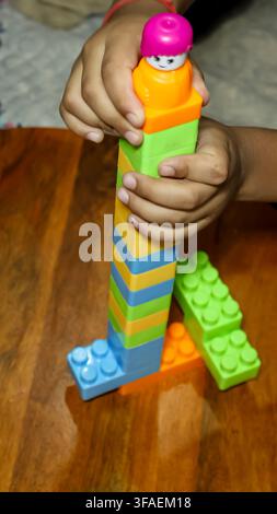 Creative Children Toy Construction Made With Colorful Plastic Blocks at indoor Stock Photo