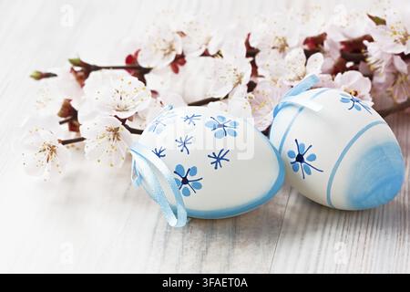 Easter egg decoration with apricot flower on wooden background Stock Photo
