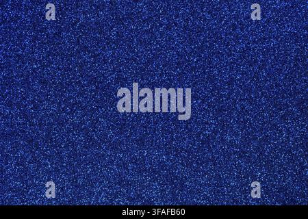 Navy blue colored sand paper textured background with sparkles and glitters Stock Photo