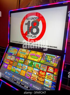 Adults-only gambling machine in a Wetherspoon pub, showing an 18+ restriction amid debate over gambling access and addiction risks. Stock Photo