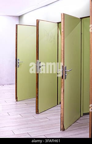 Open doors to empty restroom stalls in a public place Stock Photo