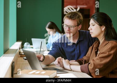 Diverse Students Studying Together with Laptop on Campus Stock Photo